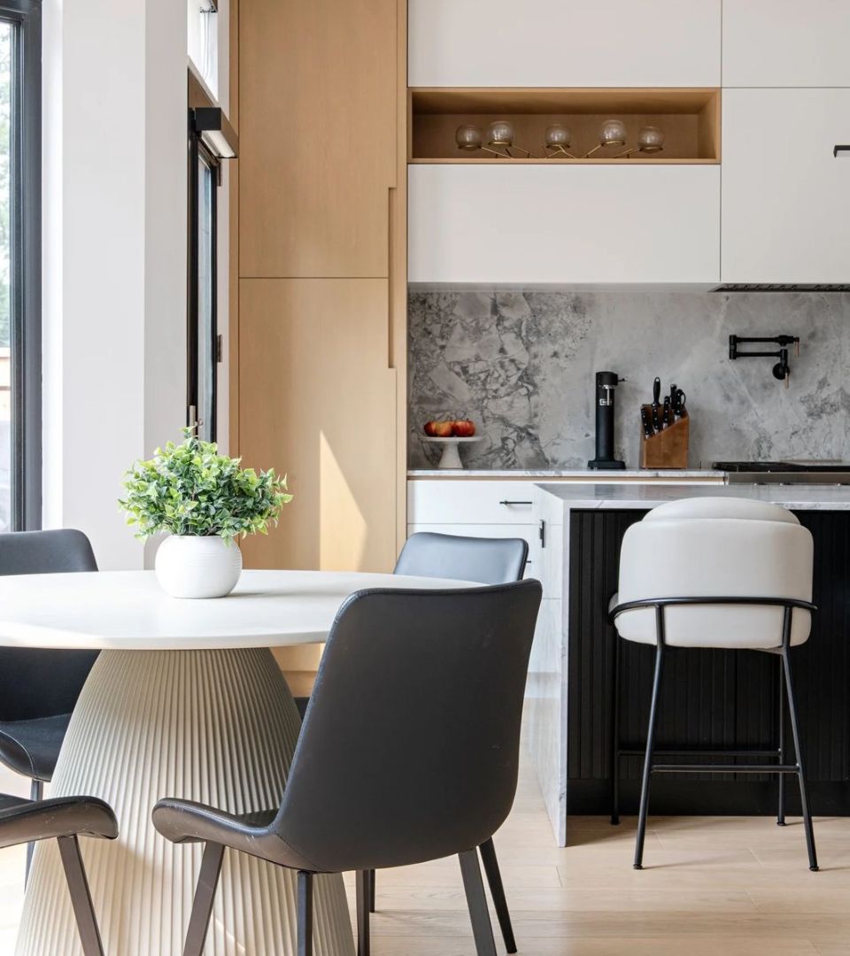 Contemporary open kitchen and dining area with custom cabinetry.‎