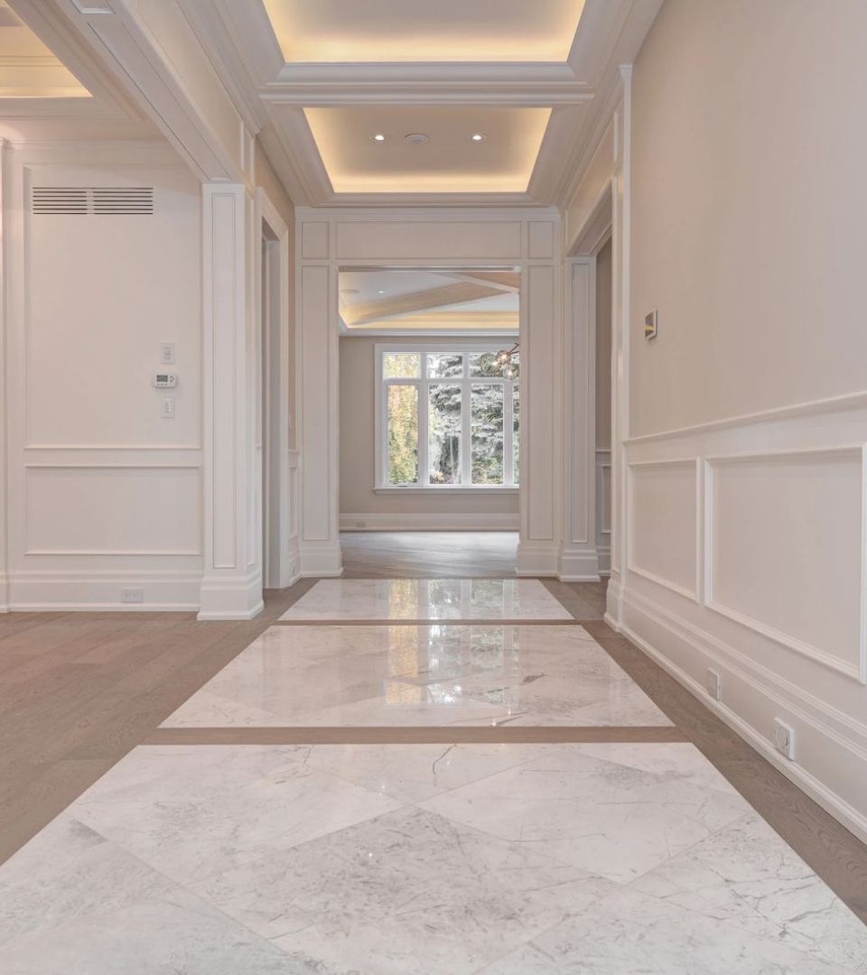 Bright entryway with premium flooring and statement lighting.‎
